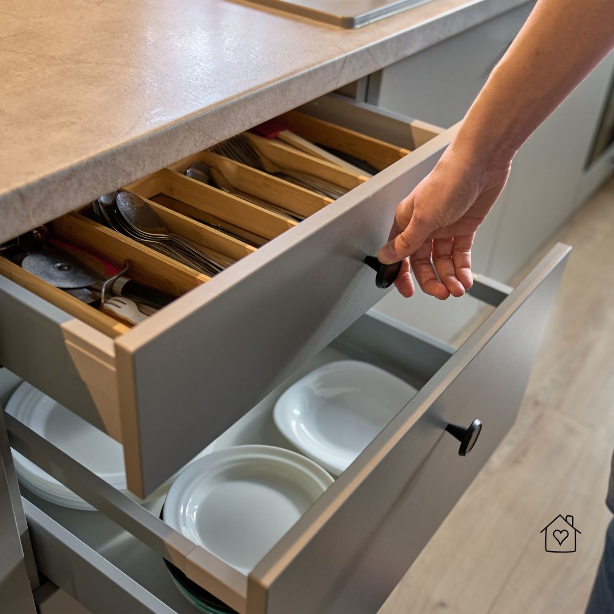 Layered drawer strategy&mdash;shallow insert for utensils; deep drawer beneath for dishes to reduce upper-cabinet crowding.