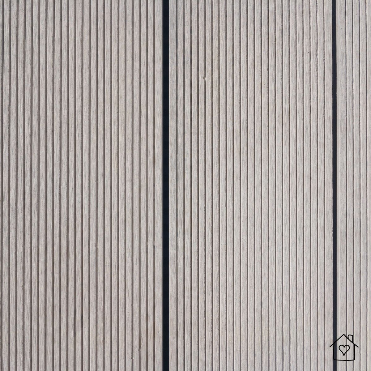 Grooved gray composite boards with narrow gaps for traction and modern linear look.