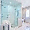 Glass Walk-In Shower With Low-Threshold Entry in Bright Bathroom
