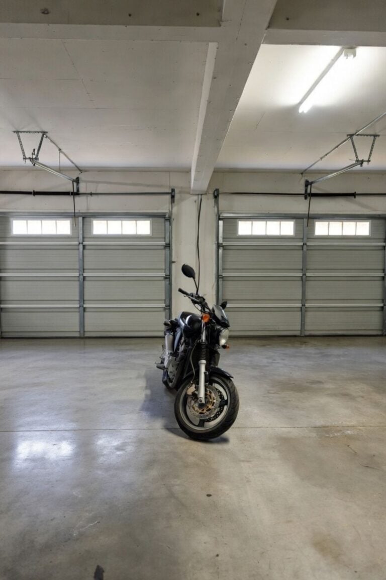 Clean, cleared garage with open floor space and a motorcycle in the center after removing clutter and organizing the area.