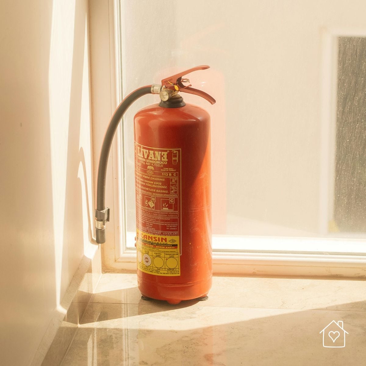 Red fire extinguisher placed inside a home as part of new homeowner fire safety preparationBest placement: In the &ldquo;Making Your San Antonio Home Fire-Safe from Day One&rdquo; section near the fire extinguisher tip