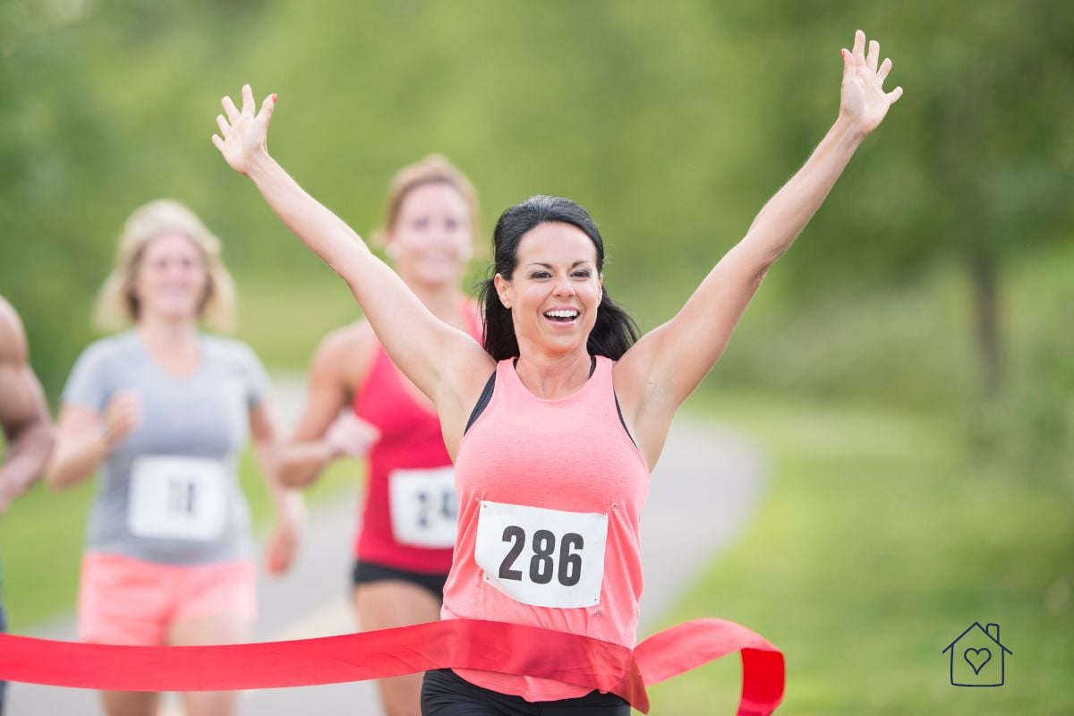 Female runner finishing a race representing busy athletes who need quick protein meals