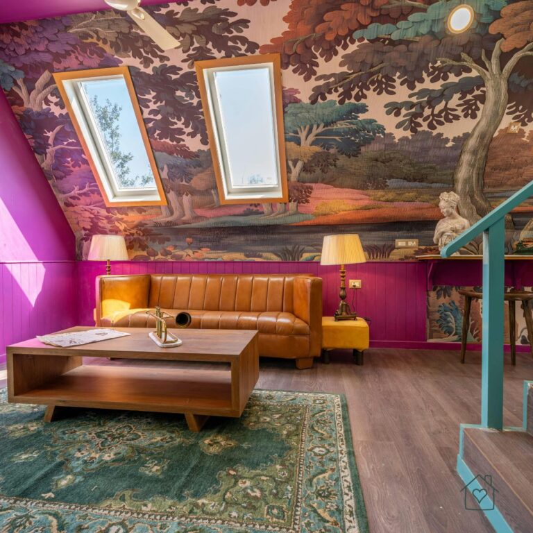 Bold living room with patterned wallpaper, leather sofa, and two roof windows bringing in natural daylight