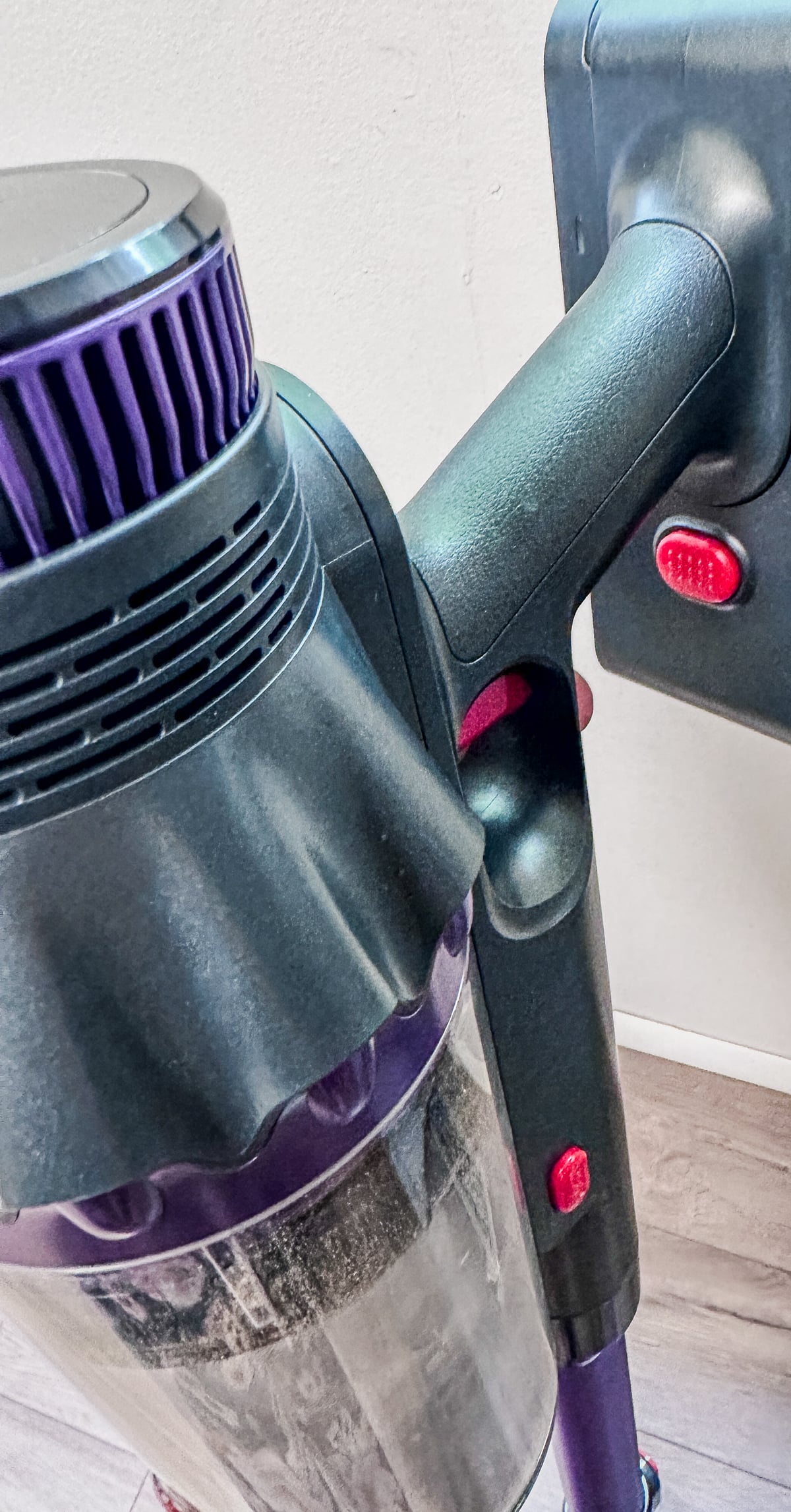 Close-up of the FEPPO cordless vacuum attached to its wall mount dock for easy storage and charging.