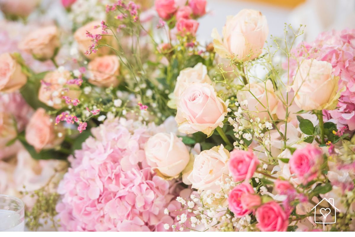 Soft pink roses, hydrangeas, baby’s breath, and fresh greenery arranged for a romantic floral display