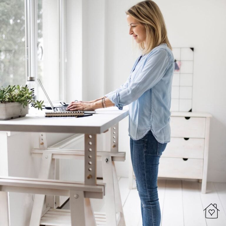 Young woman working at her standing desk in her home