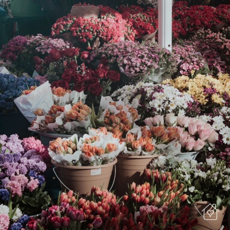 Colorful wholesale flower market filled with fresh roses, tulips, daisies, and other bulk flowers for florists and event designers