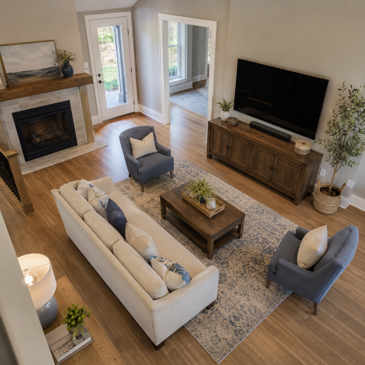 An overhead view of a living room with a sofa, chairs, and TV console arranged to leave a clear walking path between the entry and the seating area
