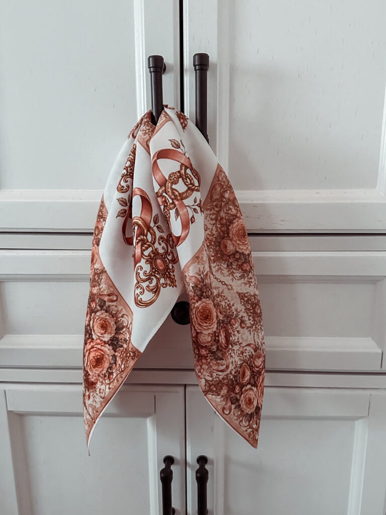 Finished DIY sublimation scarf with romantic baroque florals hanging by the corners