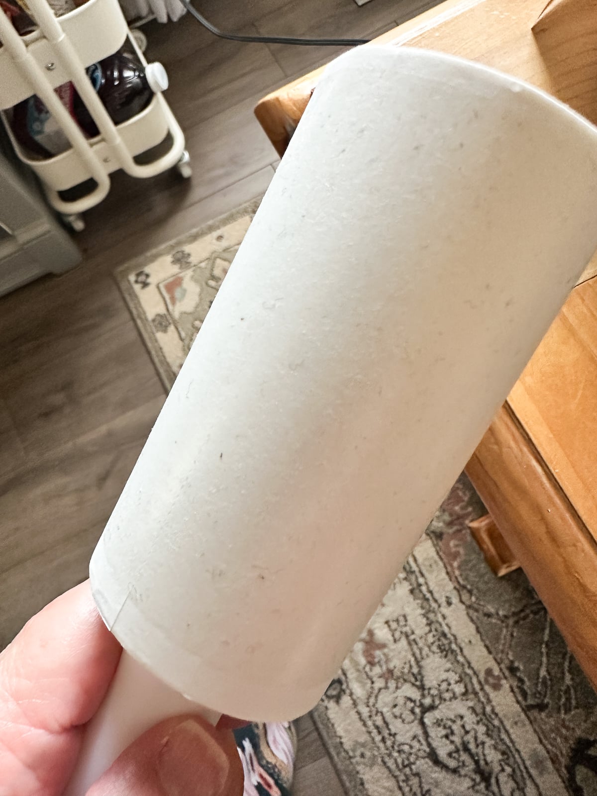 Lint roller removing dust from a white sublimation scarf blank