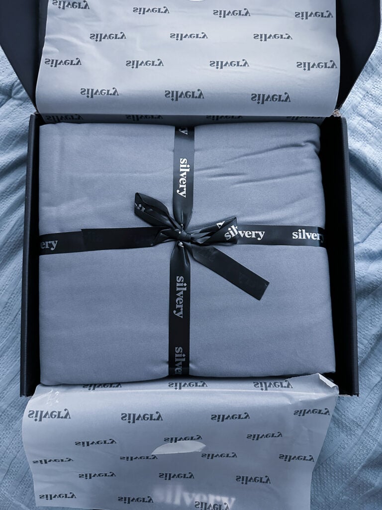 Silvery Comfort Sheets review, gray sheets tied with a black ribbon inside the branded box