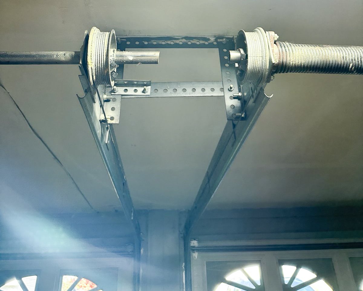 Garage door hinges and rollers running along the metal track