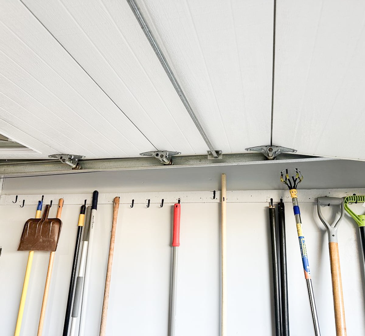 Garage door hinges and rollers running along the metal track
